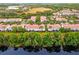 Aerial view of residential neighborhood with water feature; community near retail at 1880 Garden Sage Dr, Oviedo, FL 32765