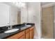 Bathroom featuring a dual sink vanity with granite countertop and tiled walk-in shower at 1880 Garden Sage Dr, Oviedo, FL 32765