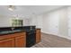 A lovely kitchen showcasing dark countertops, wood cabinets, and modern stainless steel appliances at 1880 Garden Sage Dr, Oviedo, FL 32765