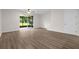 Open living space with vinyl floors leading to sliding glass doors, ceiling fan at 1880 Garden Sage Dr, Oviedo, FL 32765