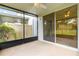 A screened patio with a ceiling fan and sliding glass doors provides access to the outdoors at 1880 Garden Sage Dr, Oviedo, FL 32765