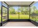 A screened patio overlooks a lush green lawn bordered by mature trees at 1880 Garden Sage Dr, Oviedo, FL 32765