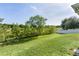 Large backyard with lush green grass and views of the surrounding trees at 1940 Bell Creek Loop, Fruitland Park, FL 34731