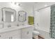Modern bathroom with double vanity, shower and tub combo and wood floors at 1940 Bell Creek Loop, Fruitland Park, FL 34731