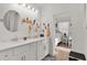 Bright bathroom featuring double sinks, a white vanity, and modern fixtures at 1940 Bell Creek Loop, Fruitland Park, FL 34731