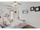 Comfortable bedroom with a mounted TV and view to the outside at 1940 Bell Creek Loop, Fruitland Park, FL 34731