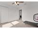 Neutral bedroom with two white closet doors and natural light beaming across the room at 1940 Bell Creek Loop, Fruitland Park, FL 34731