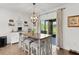 Breakfast nook with a wooden table, gray upholstered stools, and sliding glass doors at 1940 Bell Creek Loop, Fruitland Park, FL 34731