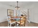 Traditional dining room with wood table, decorative chandelier, and easy access to the stairway at 1940 Bell Creek Loop, Fruitland Park, FL 34731