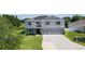 Attractive two-story home with solar panels, complemented by a well-kept lawn and three car garage at 1940 Bell Creek Loop, Fruitland Park, FL 34731