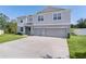 Beautiful two-story home with a three-car garage and an expansive driveway and landscaped yard at 1940 Bell Creek Loop, Fruitland Park, FL 34731