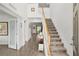 Bright foyer with stairway and views into the open-concept living areas and natural light at 1940 Bell Creek Loop, Fruitland Park, FL 34731