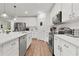 Well-equipped kitchen with stainless steel appliances, white cabinetry, and a spacious countertop at 1940 Bell Creek Loop, Fruitland Park, FL 34731