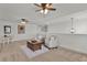 Upstairs living area with neutral carpet, a chandelier, and an area for playing games at 1940 Bell Creek Loop, Fruitland Park, FL 34731
