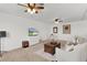Upstairs living room with ceiling fans, neutral carpet, and a comfortable seating arrangement at 1940 Bell Creek Loop, Fruitland Park, FL 34731
