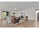 Open-concept living room with modern decor and wood-look tile flooring throughout at 1940 Bell Creek Loop, Fruitland Park, FL 34731