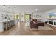 Open-concept living room featuring wood floors, ample natural light, and a comfortable, inviting aesthetic at 1940 Bell Creek Loop, Fruitland Park, FL 34731