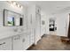 Beautiful main bathroom featuring double sinks and a view into the main bedroom at 1940 Bell Creek Loop, Fruitland Park, FL 34731