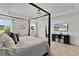 Bright main bedroom featuring a four-poster bed, tray ceiling and neutral decor at 1940 Bell Creek Loop, Fruitland Park, FL 34731