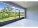 Screened patio with a view of the spacious backyard and lush trees at 1940 Bell Creek Loop, Fruitland Park, FL 34731