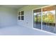 Outdoor patio with sliding doors leads to a tranquil screened in area at 1940 Bell Creek Loop, Fruitland Park, FL 34731