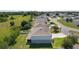 A rear exterior view reveals a meticulously kept lawn, complemented by solar panels on the roof and a white fence at 1940 Bell Creek Loop, Fruitland Park, FL 34731