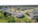 An exterior aerial view displays the home's well-maintained backyard and its position within a vibrant neighborhood at 1940 Bell Creek Loop, Fruitland Park, FL 34731