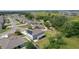 A panoramic shot of the house, complemented by solar panels, shows a yard backing onto lush conservation land at 1940 Bell Creek Loop, Fruitland Park, FL 34731