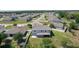 This elevated rear view showcases the home's screened-in patio and generous yard, enhancing its outdoor appeal at 1940 Bell Creek Loop, Fruitland Park, FL 34731