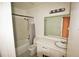 Bathroom featuring tiled shower and tub, large vanity, and neutral color scheme at 2117 Lyme Bay Dr # 604, Orlando, FL 32839