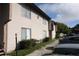 Two story condo building with light beige siding and well manicured landscaping at 2117 Lyme Bay Dr # 604, Orlando, FL 32839