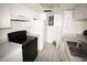 A kitchen featuring tiled floors, white cabinets, and black appliances at 2117 Lyme Bay Dr # 604, Orlando, FL 32839