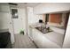 A kitchen featuring white cabinets, tiled floors and stainless steel double sinks at 2117 Lyme Bay Dr # 604, Orlando, FL 32839