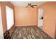 Living room with new floors, ceiling fan, and large window, adjacent to kitchen at 2117 Lyme Bay Dr # 604, Orlando, FL 32839