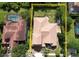 This aerial view shows the home's tile roof, backyard, and proximity to a neighbor's pool and surrounding trees at 2408 Dahlgren Way, Winter Garden, FL 34787