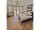 Bright main bedroom features tiled flooring, stylish furniture, and a cozy sitting area at 2408 Dahlgren Way, Winter Garden, FL 34787