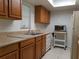 Bright kitchen with a double sink, wood cabinets, and plenty of counter space at 2408 Lemon Tree Ln # C, Orlando, FL 32839