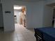 Bright kitchen view from dining area featuring wood cabinets and white appliances at 2408 Lemon Tree Ln # C, Orlando, FL 32839