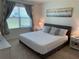 Well-lit bedroom featuring a queen-sized bed, plush carpet, and an abstract art piece at 2688 Magnolia Ave, Davenport, FL 33837