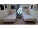 Comfortable bedroom with twin beds, neutral carpet, and window with natural light at 2688 Magnolia Ave, Davenport, FL 33837
