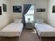 Bright bedroom featuring twin beds, stylish decor, and a window with natural light at 2688 Magnolia Ave, Davenport, FL 33837