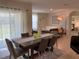 Open-concept dining area with modern chairs and a view into the inviting living room at 2688 Magnolia Ave, Davenport, FL 33837