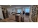 Open-concept kitchen with granite countertops, stainless steel appliances, and a view into the dining area at 2688 Magnolia Ave, Davenport, FL 33837