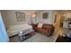 Comfortable living area with white and brown leather sofas, natural light, and decorative accents at 2688 Magnolia Ave, Davenport, FL 33837
