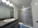 Modern bathroom featuring a tile surround walk-in shower and vanity sink at 280 Harper Estates Cir, Lake Wales, FL 33859