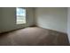 Carpeted bedroom with a large window that provides natural light at 280 Harper Estates Cir, Lake Wales, FL 33859