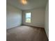 Cozy bedroom with carpet floors and natural light from a single window at 280 Harper Estates Cir, Lake Wales, FL 33859