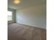 Carpeted bedroom with natural light from a large window at 280 Harper Estates Cir, Lake Wales, FL 33859