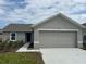 Single story home featuring a well-manicured lawn and attached two car garage at 280 Harper Estates Cir, Lake Wales, FL 33859