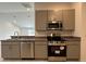 Modern kitchen featuring stainless steel appliances and gray cabinets at 280 Harper Estates Cir, Lake Wales, FL 33859